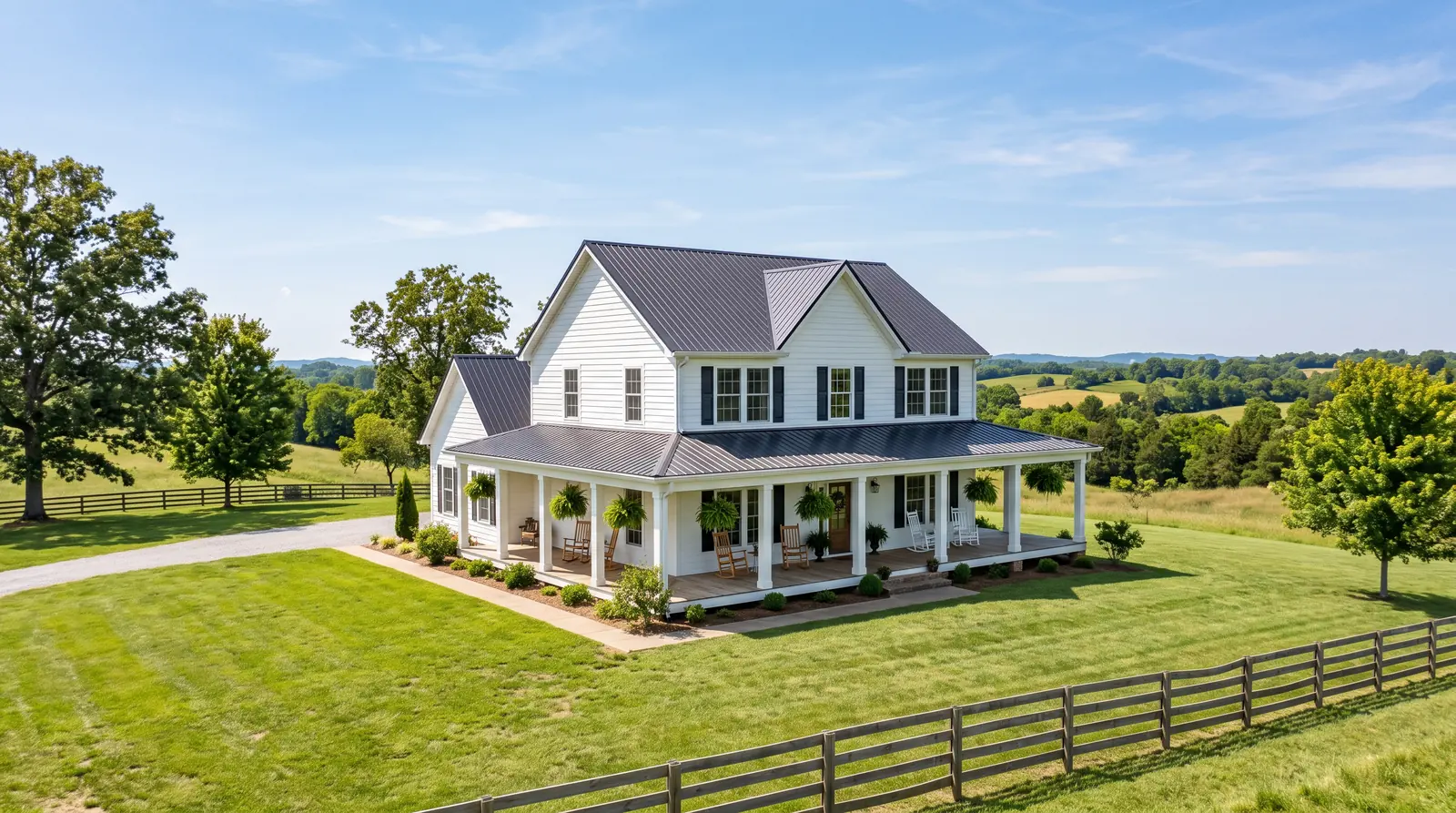 A white farmhouse-style country home in rural Middle Tennessee with a wide covered porch, rocking chairs and rolling green hills behind it